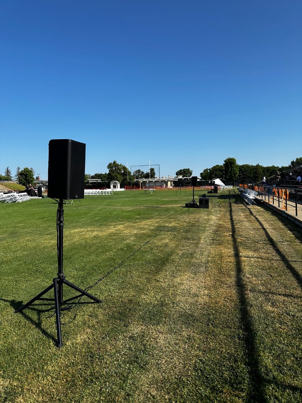 Professional powered speaker on a stand covering a high school football field for graduation